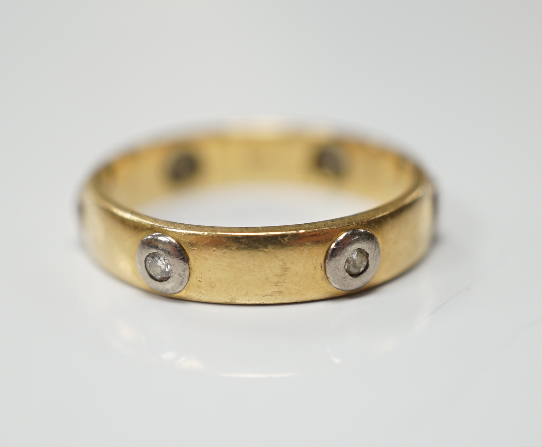 A modern Cartier 18ct gold and six stone diamond set band, signed and numbered 441404, size L, gross weight 3.3 grams, no box or certificate.